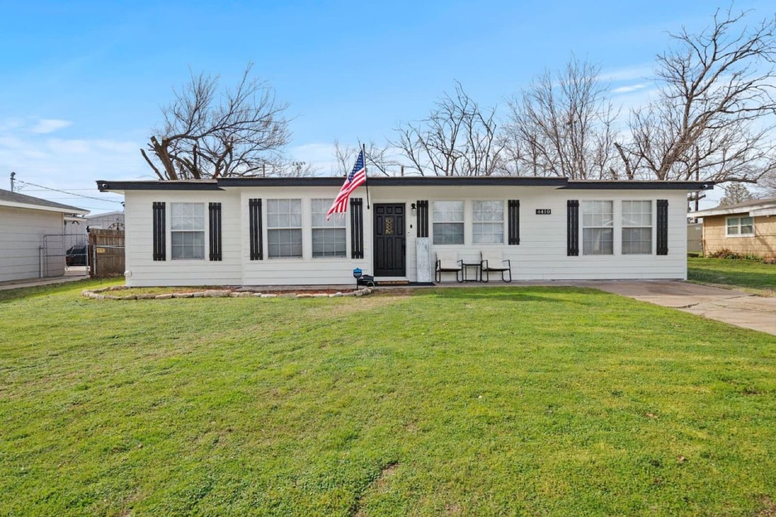 An All American Cottage exterior with a flag by the front door